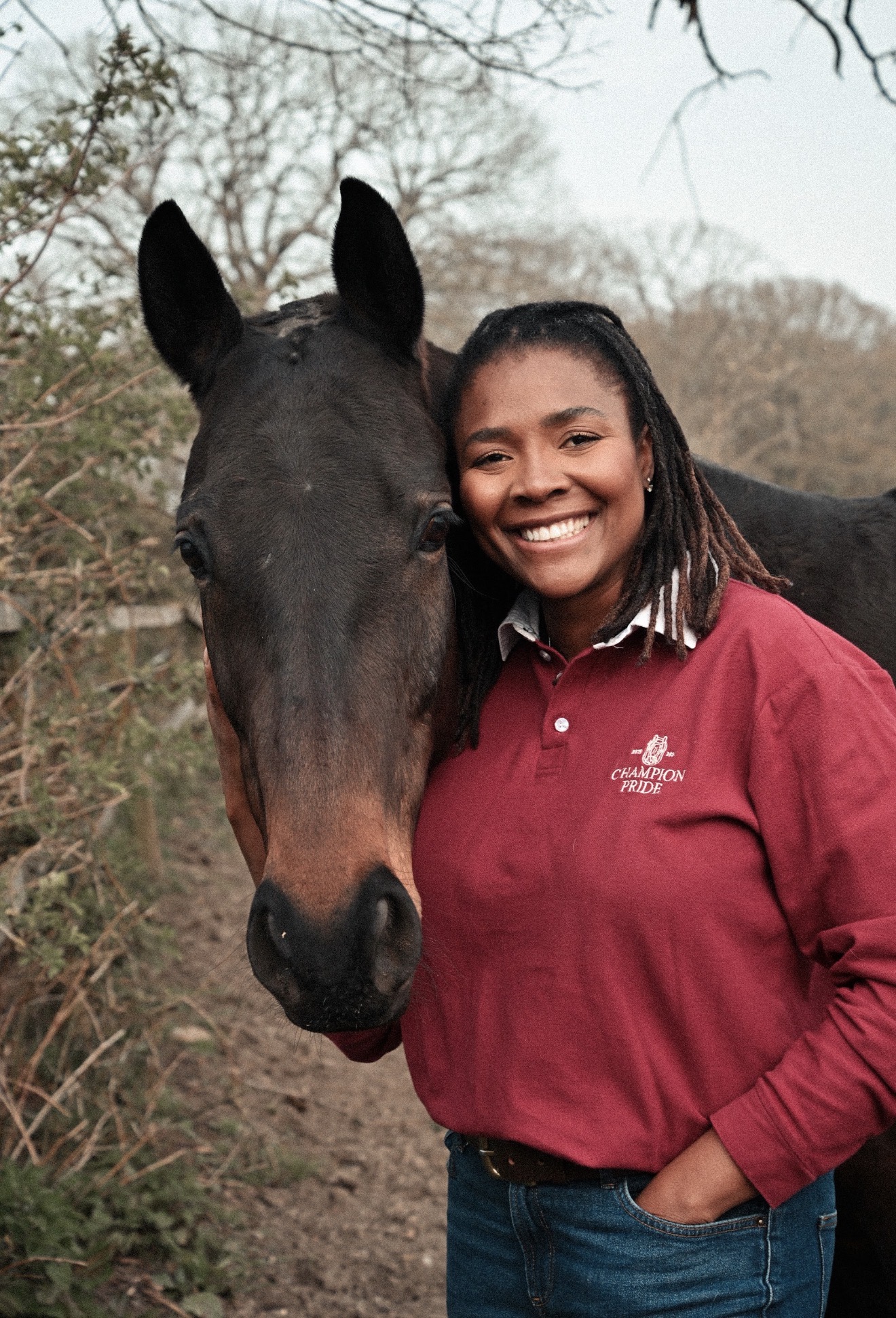 A Champion Pride handler beside a bay horse