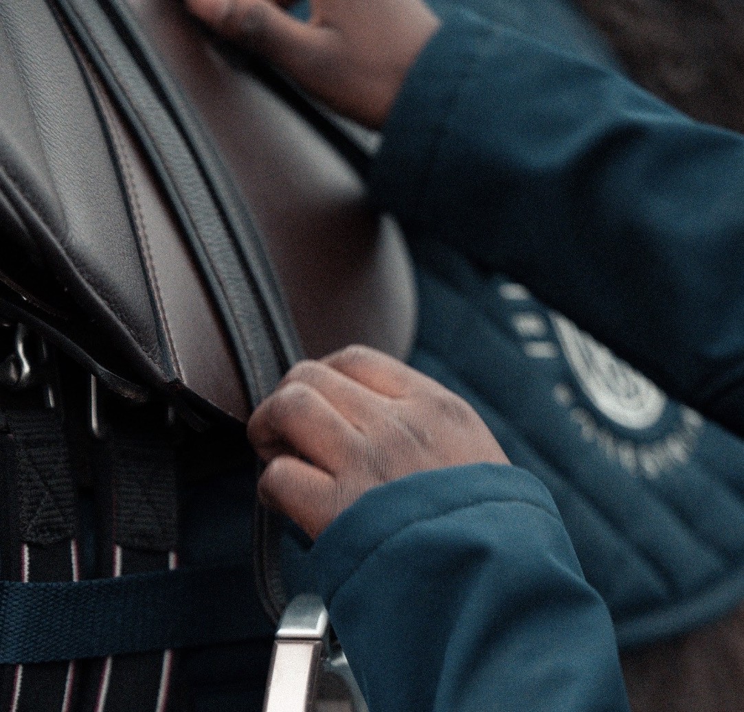 Hands adjusting a saddle
