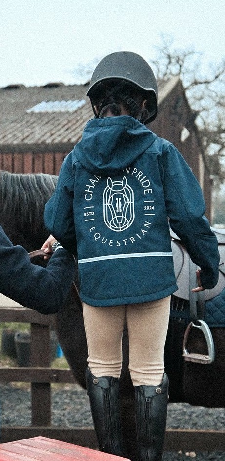 A young rider mounting a horse